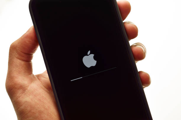 Software updating in apple iphone in hand stock photo