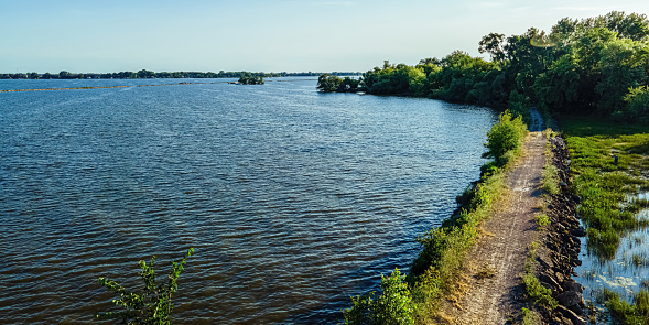 A desolate view as the sun shines brightly over the Fox River with a view of the breakwall near Oshkosh