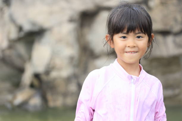 Japanese student girl playing in the river (7 years old)