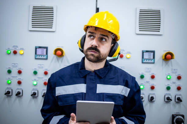 istock Portrait of worried electrical engineer or serviceman trying to detect and fix the problem in factory. 1416206104