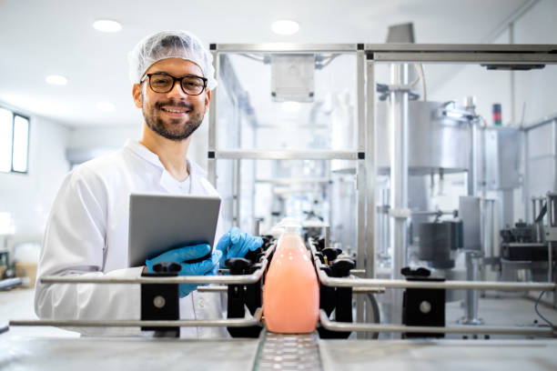 istock Production line worker or technologist standing by the automated conveyor machine with liquid soap products and cleaning chemicals. 1416208559