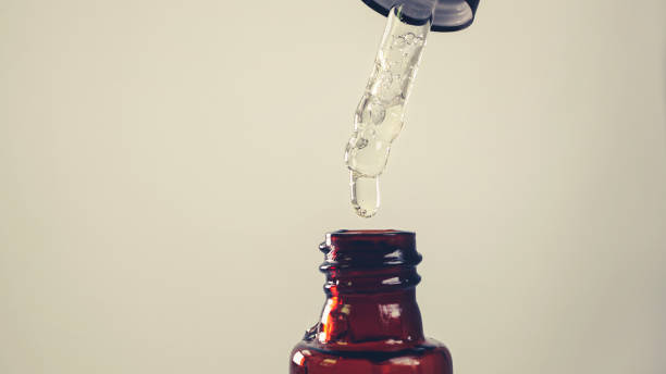 istock Close up essential drop into  bottle , cosmetic , chemical , essential oil drop using concept 1416211117