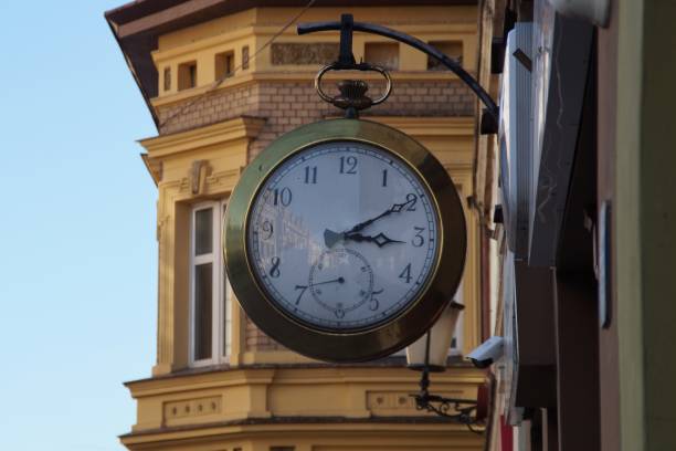 istock clock hanging above the street 1416211225