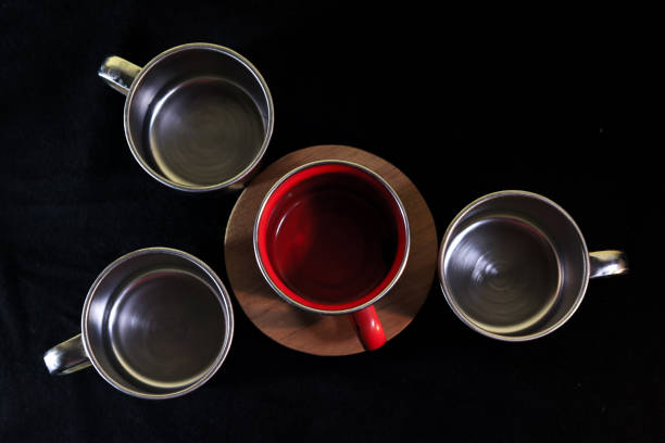 Top view Red mug and silver mug with black bacground