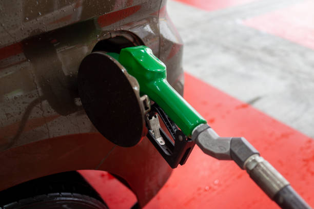istock Close up of Gas pump inserted into car 1416216984