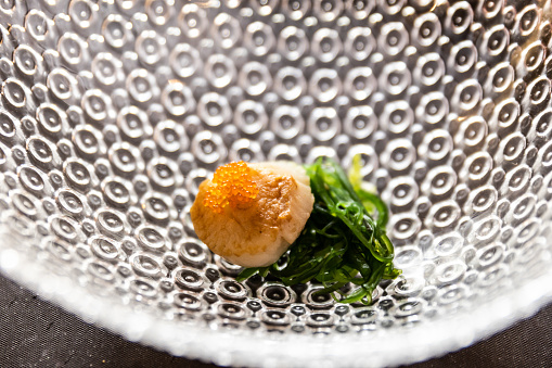 Plate of scallop and tobiko eggs on a designer plate. Healthy eating lifestyle - Fotografía de stock