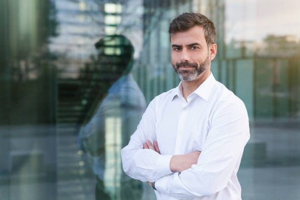 Businessman looking at camera outdoors