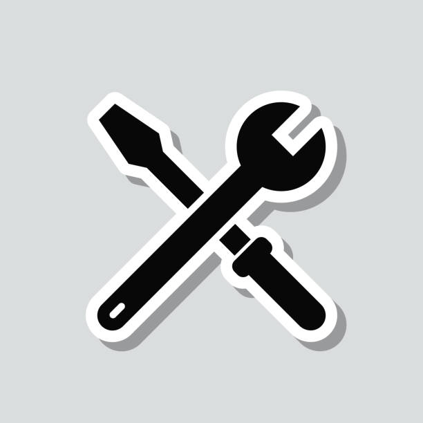 werkzeuge - schraubenschlüssel und schraubendreher. symbolaufkleber auf grauem hintergrund - wrench screwdriver work tool symbol stock-grafiken, -clipart, -cartoons und -symbole