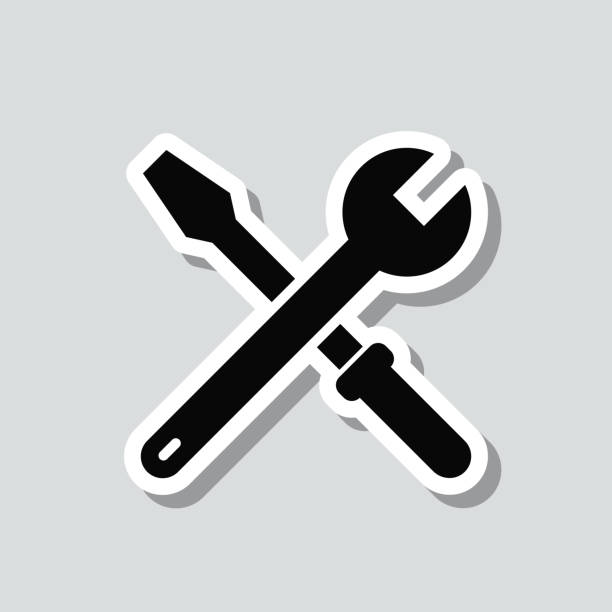Tools - Wrench and screwdriver. Icon sticker on gray background Icon of "Tools - Wrench and screwdriver" on a sticker with a drop shadow isolated on a blank background. Trendy illustration in a flat design style. Vector Illustration (EPS file, well layered and grouped). Easy to edit, manipulate, resize or colorize. Vector and Jpeg file of different sizes. mechanic workshop stock illustrations