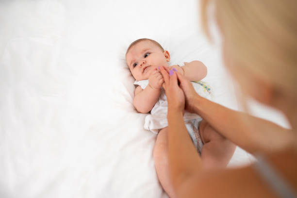 istock Playing with the baby lying on the bed. 1416257184