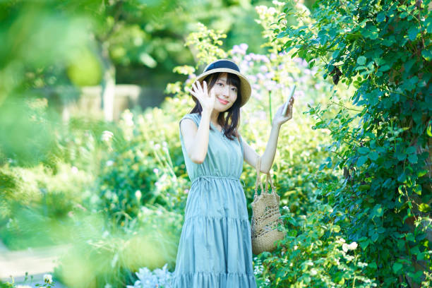 young woman taking pictures while walking in summer