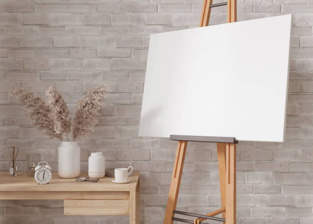 istock Empty horizontal canvas on wooden easel in modern and cozy room. Canvas mock up, interior in scandinavian, boho style. Free, copy space for your picture. Artwork presentation. 3D rendering. 1416268817