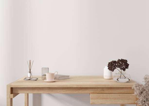 istock Empty white wall. Mock up interior in contemporary style. Close up view. Copy space for your picture, poster, text, or another design. Desk, vase with dried plants, other home accessories. 3D render. 1416268824