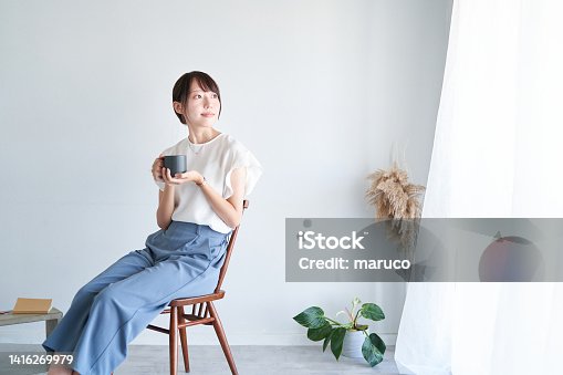 istock A woman relaxing in a simple space 1416269979