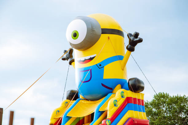 Huge inflatable figure one-eyed yellow minion. Inflatable children's attraction trampoline in a public park. St. Petersburg, Russia - 07.11.2022: Huge inflatable figure one-eyed yellow minion. Inflatable children's attraction trampoline in a public park. minion smile stock pictures, royalty-free photos & images