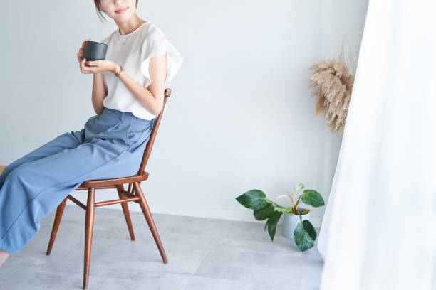 istock A woman relaxing in a bright indoor space 1416274287