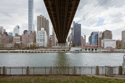 View of the Williamsburg Bridge seen from East River in New York City, USA