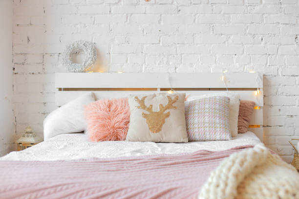 istock Cozy double bed in Christmas style in a modern bedroom interior 1416308131