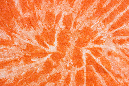 orange abstract pattern handcrafted in batik technique on cotton jersey fabric
