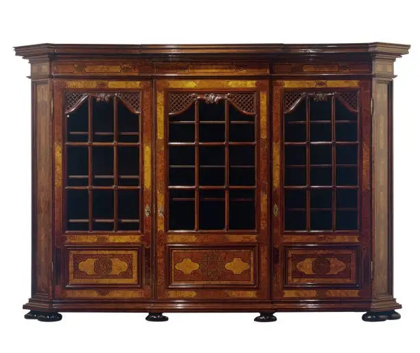 Photo of Antique huge wooden cabinet with glasses door isolated on white