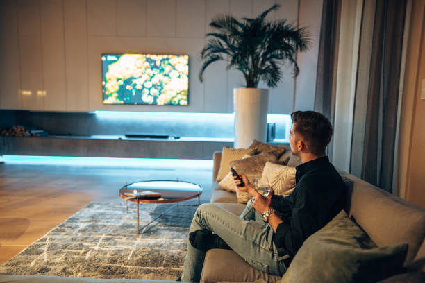 istock man working on the couch and watching tv 1416320046