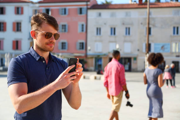 istock Tourist in town square taking photos 1416320586