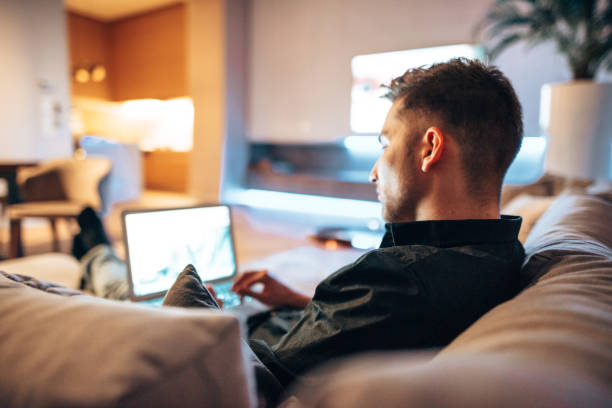 istock man working on the couch and watching tv 1416322739