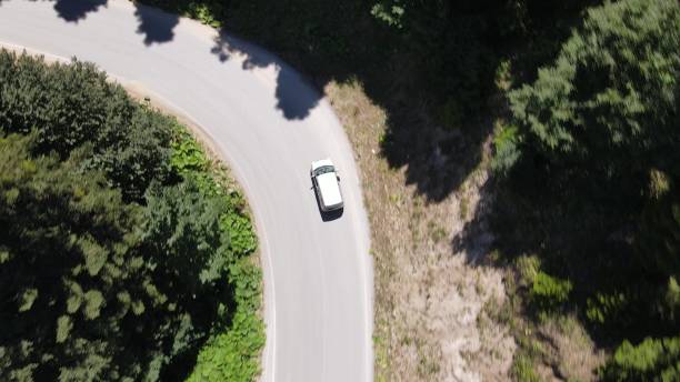 istock Drone footage of Zigzag Road between Forest 1416327756