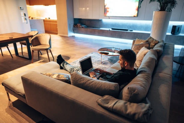 istock man working on the couch and watching tv 1416328856