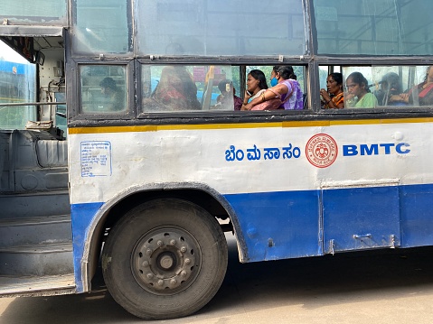 Bengaluru, India - April 2022: A BMTC Public transport bus run by the government on the streets of the city of Bengaluru.