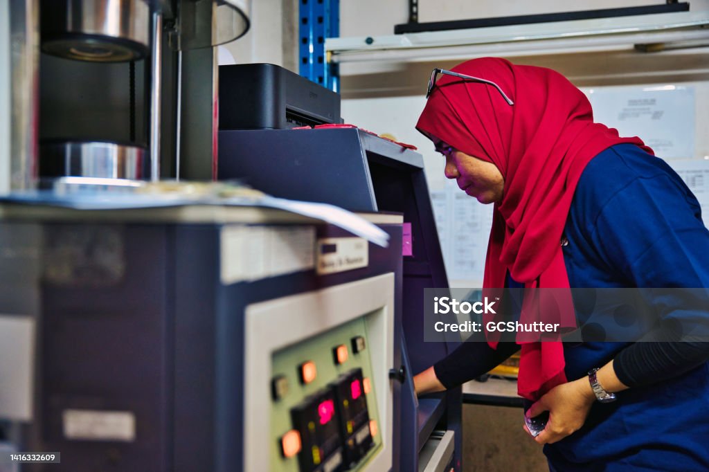 Female QC inspectors in a factory Asian women working as a team in a factory Working Stock Photo