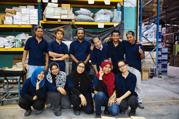 Group of factory workers facing the camera for a team photograph
