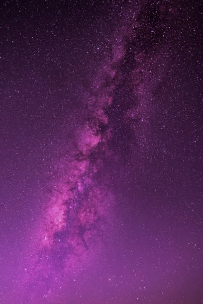purple and blue night sky milky way and star on dark background.with noise and  grain.photo by long exposure and select white balance. - milky way imagens e fotografias de stock