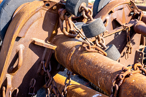 Close-up of a rusty chains on metal mast and bobbers on a shipyard. With copy space. Shot with a 35-mm full-frame 61MP Sony A7R IV.