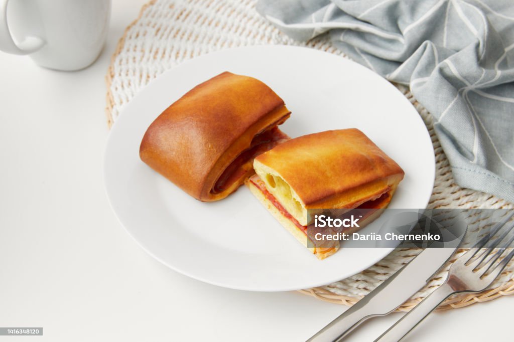 Lanche misto traditional portuguese sandwich with cheese and chorizo. Tasty breakfast over white background Lanche misto traditional portuguese sandwich with cheese and chorizo. Tasty breakfast over white background. Restaurant cafe menu. Appetizer Stock Photo