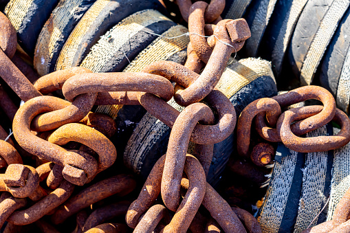 Rusty chains and bobbers on a shipyard. With copy space. Shot with a 35-mm full-frame 61MP Sony A7R IV.