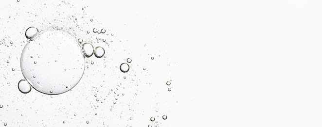 The texture of a cosmetic serum with bubbles in closeup. Copy space.