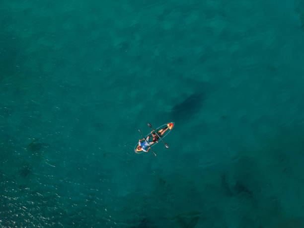 istock couple paddling transparent kayak from above 1416351012