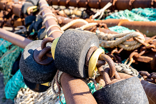 Bobbers, rope and fishing equipment on a shipyard. With copy space. Shot with a 35-mm full-frame 61MP Sony A7R IV.