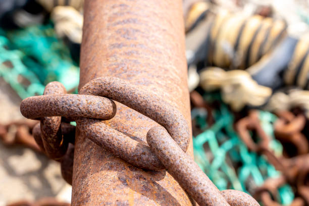 Close-up of a rusty chain on a rusty tube on a shipyard. With copy space. Shot with a 35-mm full-frame 61MP Sony A7R IV.