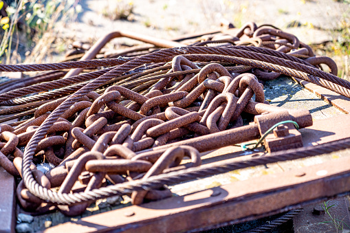 Rusty chains and cables on rusty metal plate on a shipyard. With copy space. Shot with a 35-mm full-frame 61MP Sony A7R IV.