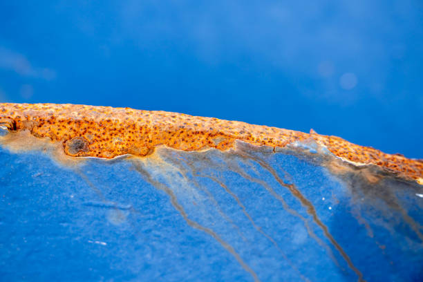 Close-up of rusty edge of a blue metal plate. With copy space. Shot with a 35-mm full-frame 61MP Sony A7R IV.