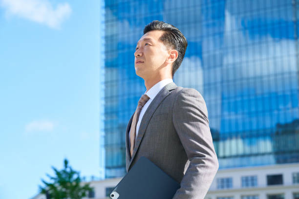 istock businessman standing in office district 1416377169
