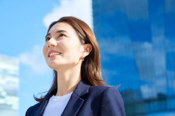 istock business woman standing in office district 1416387716