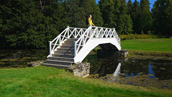 Female tourist with backpack standing on the bridge.