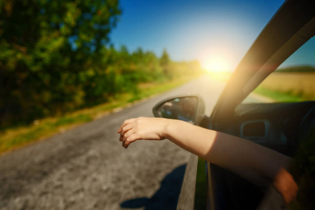 istock Woman's hand outside car window. Summer vacations concept. 1416400512