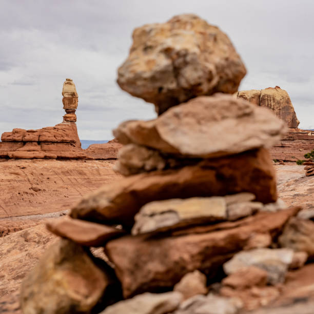 Shaman Rock Stands Tall With A Cairn In The Foreground along the Peekaboo Trail in Canyonlands