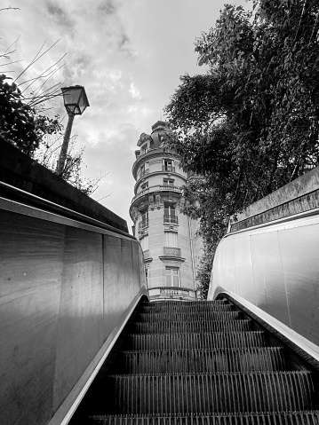 On an escalator looking up, near the bridge Pont de Bir-Hakeim and the metro station Passy. 06/05/2022 - Quartier Passy, 75116 Paris, France