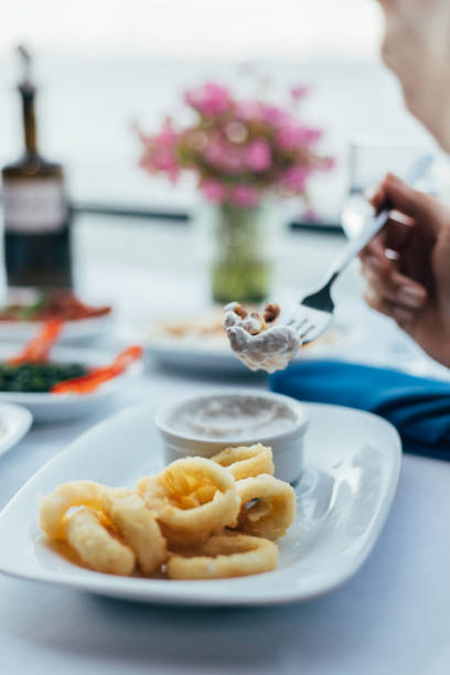 istock Eating fried calamari with tartar sauce 1416412312