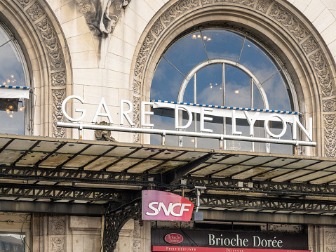 Lettering with white letters in front of the building facade of the Gare de Lyon train station. including the lettering SNCF of the National society of French railroads. 06/08/2022 - Place Louis-Armand, 12th arrondissement, 75012 Paris, France